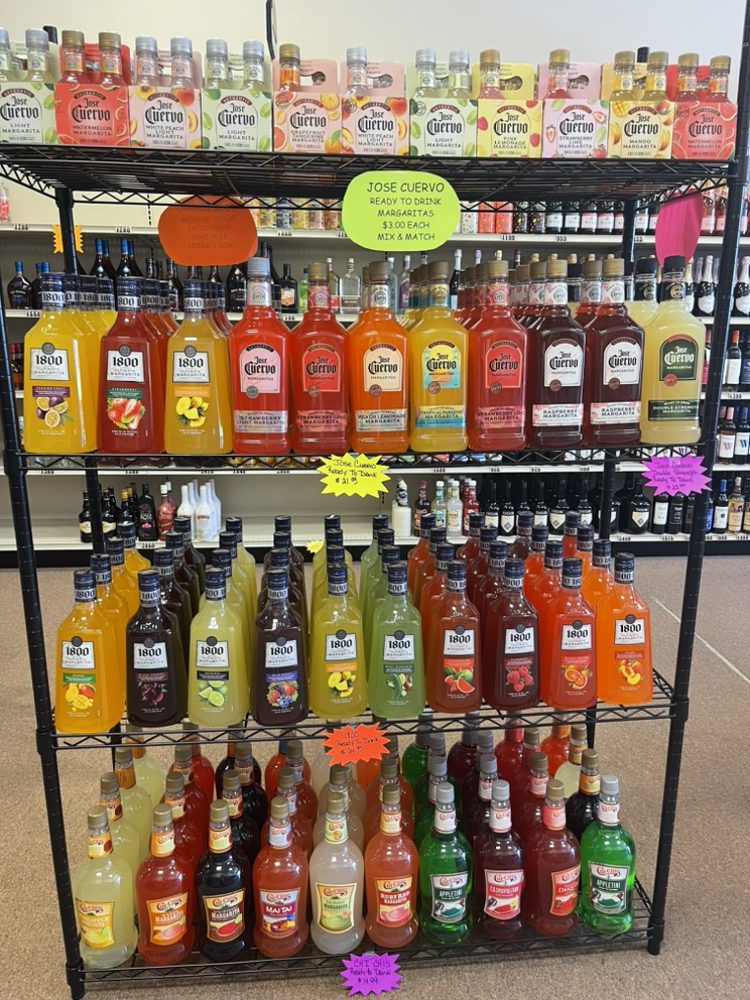Selection of different flavored Jose Cuervo & 1800 on a rack in our store