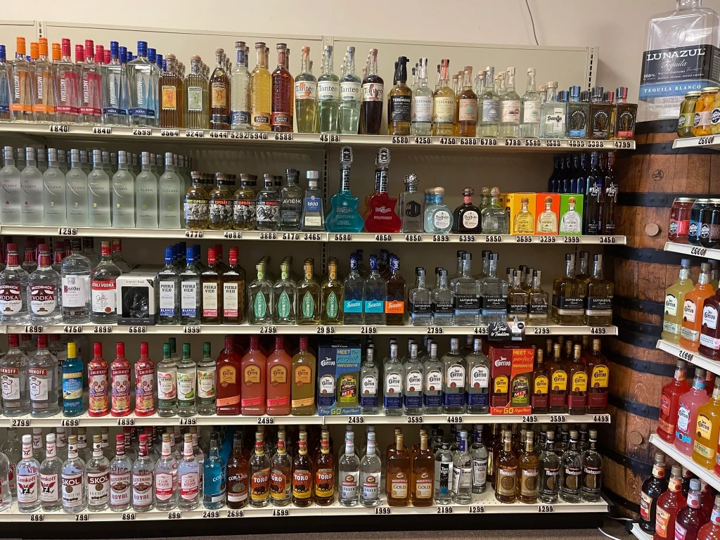 Inside our store, shelves filled with vodka on the left and tequila on the right.