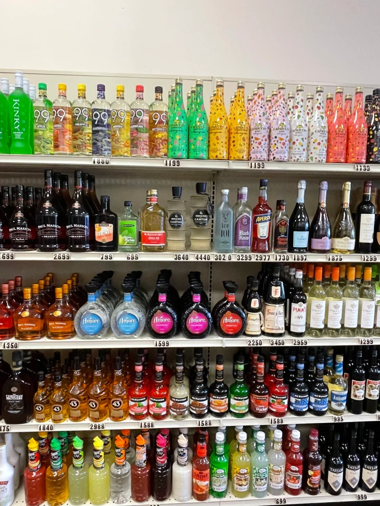 A shelf stocked with cocktail mixes for your adult beverage needs.